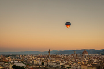 A hot balloon at sunrise over Florence