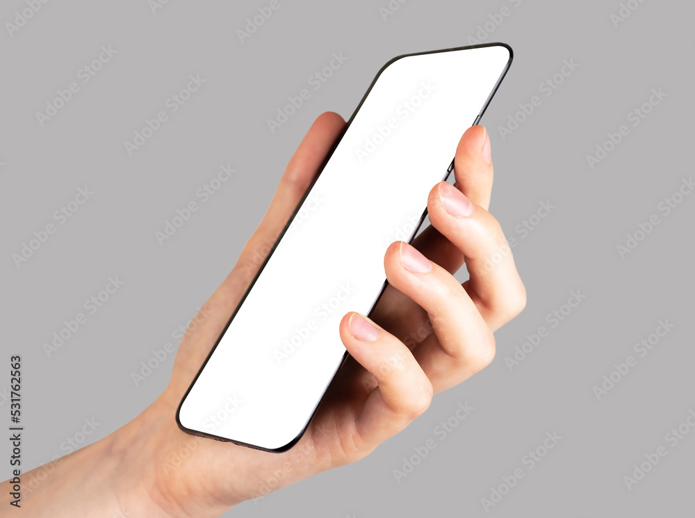 Poster hand holding phone mockup on grey background. angled view. template with white screen. electronic de