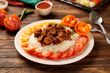 Hamsa prawns with white rice, tomato and sauce served in a dish isolated on wooden table background side view of fastfood