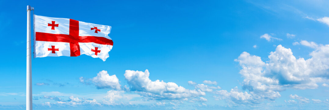 Georgia flag on a blue sky *** Horizontal banner 12000 x 4000 px