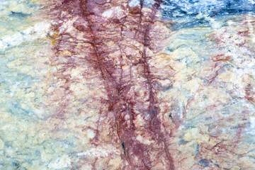 Natural stone marble rock surface by the stream.  Stone marble texture background.Selective focus.