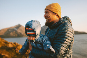 Father and child traveling together outdoor in Norway family vacations lifestyle man playing with...