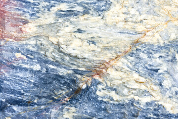 Natural stone marble rock surface by the stream.  Stone marble texture background.Selective focus.