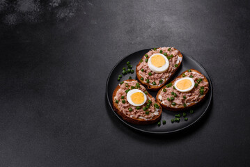 Delicious healthy sandwich with tuna, croutons, boiled egg, herbs and butter