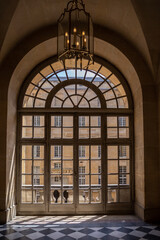 An ancient arch window in a general plan in the Palace of Versailles.