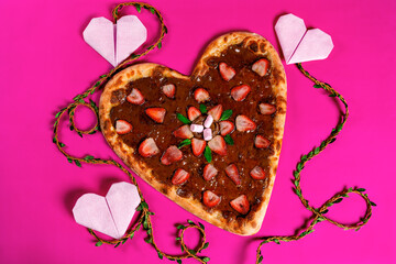 heart on a pink background. heart-shaped pizza. valentine's day pizza. strawberry pizza with chocolate cream. heart-shaped meat pizza. love pizza. 