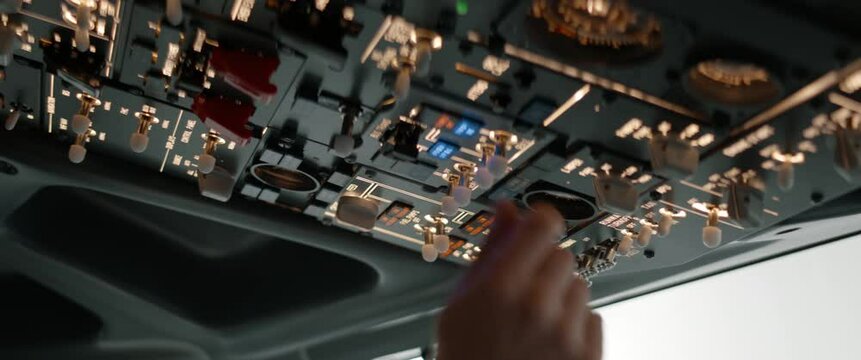 CU Commercial aircraft pilots adjusting flight parameters of the plane during the flight at high altitude. View from inside the cabin. Real aircraft, daytime shot