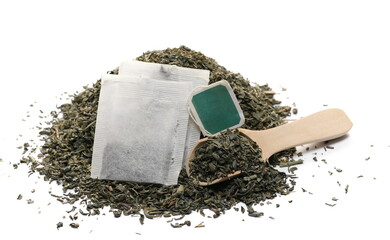 Green tea pile in wooden spoon and tea bag filter isolated on white 