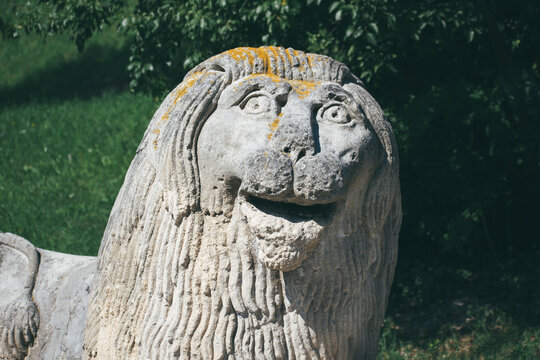 Ancient sculpture of a lion. Joyful lion