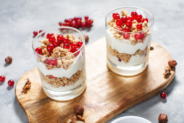Healthy breakfast menu concept. Morning granola breakfast with berries served with yogurt in glasses