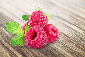 Fresh ripe raspberries berry on kitchen desk.