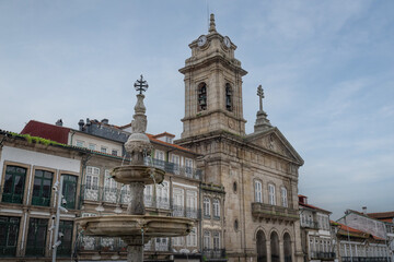 Fototapeta na wymiar St. Peter Basilica and Toural Fountain at Largo do Toural Square - Guimaraes, Portugal