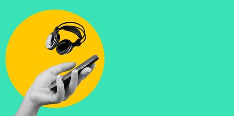 Hand with phone and modern headphone for listen music