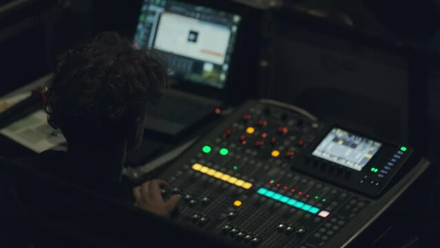 Sound engineer using laptop during work