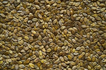 Pumpkin seeds photographed from above. Image can be used as background or to insert text.