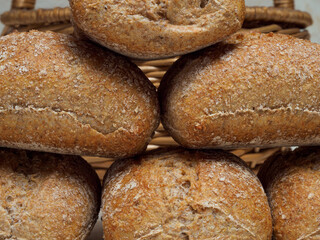 rustic wholemeal breads with a basket in the background