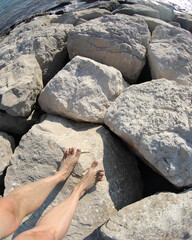 two feet on the rock by the sea
