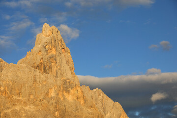 mountain called Cimon della Pala on Dolomites in Italy colored orange by optical phenomenona called...