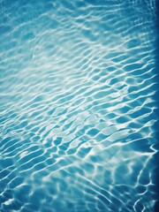 Bluewater waves on the surface ripples blurred. Defocus blurred transparent blue colored clear calm water surface texture with splash and bubbles. Water waves with shining pattern texture background.