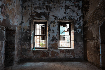 Fototapeta na wymiar Abandoned building. Broken Windows and peeled walls of an historical building