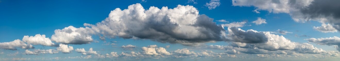 Fantastic clouds against blue sky, panorama