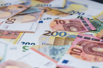 Lots of different Euro banknotes shown as a mess