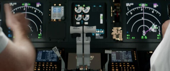 Commercial aircraft pilots controlling airplane throttle lever during the flight or take off. View from inside the cabin. Real aircraft, daytime shot