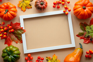 Autumn flat lay background. Pumpkins and fall leaves. Autumn decorations with copy space.