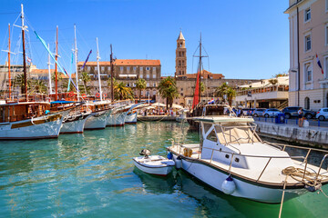 Fototapeta na wymiar Coastal summer cityscape - view of the embankment the Old Town of Split with the Palace of Diocletian and bell tower of the Cathedral of Saint Domnius, the Adriatic coast of Croatia