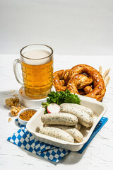 Traditional Oktoberfest set. Pretzels, beer, smoked pork knuckle eisbein with mustard