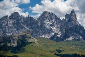 Fototapeta premium Mountains view from Malga Bocche, Trentino, Italy. Cloudy sky and green meadows.
