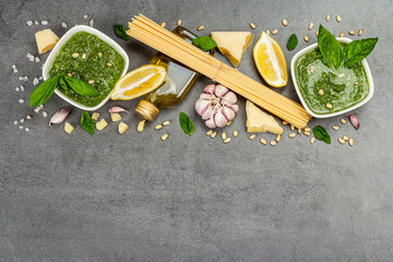 Traditional ingredients for the preparation of classic Italian pasta. Dry spaghetti, basil pesto