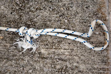 Nautical rope on concrete background. Ship rope