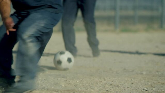 Prisoners playing soccer,  Inmates playing Soccer, slow motion, dusty court, non descript, mexican, black, latino