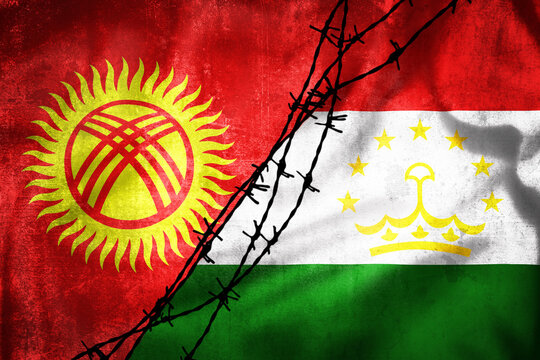 Grunge flags of Kyrgyzstan and Tajikistan divided by barb wire illustration