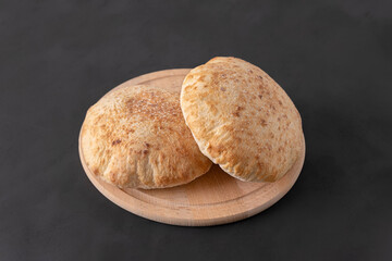 Pita bread on dark background. Arabic, lebanese bread, traditional food