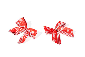 Red holiday bows on white background