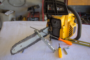 Image of a chainsaw with tools to sharpen the chain. Preparation of tools for the winter and do-it-yourself work
