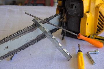 Image of a chainsaw with tools to sharpen the chain. Preparation of tools for the winter and...