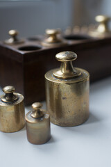 Three units of weight measure. Set in a wooden box in the background