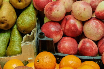 Fruit stall at the farmers market. Bright ripe fruits of plants are laid out for sale. Small business retail concept. Selective focus