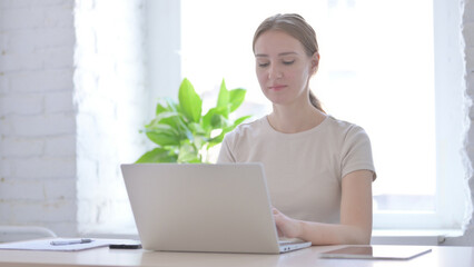 Busy Woman Typing on Laptop in Office