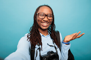 Cheerful smiling heartily african american professional photographer recording daily vlog video....