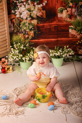 portrait girl one year old shooting in the studio in the background flowers wooden background dekor 