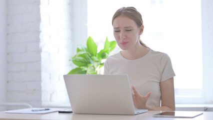 Woman Reacting to Financial Loss While using Laptop