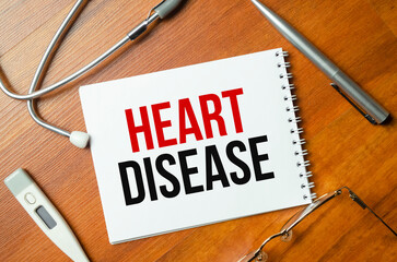 Heart disease with notepad with stethoscope on desk
