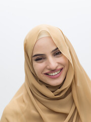 Portrait of young muslim woman wearing hijab on isolated white background