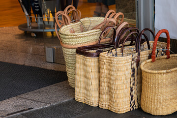 Several wicker baskets standing on the threshold of the store.