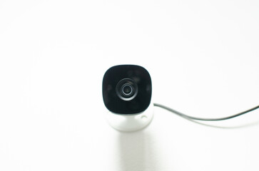 CCTV videocam, CFTV security camera, white camera with secure circuit, theft protection. Surveillance view.