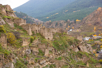 Fototapeta premium Old stone town Kakhib, Dagestan, Russia. Ancient towers, ruins and houses on the rocks. Panoramic view of the city on the mountains